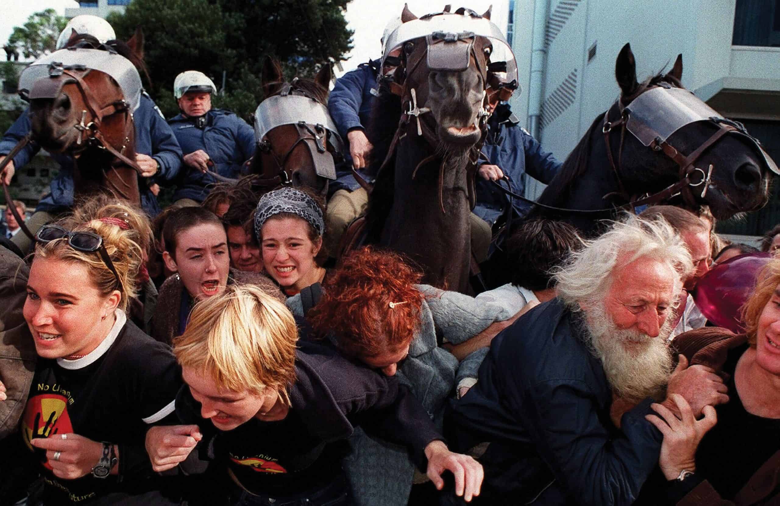 police on horses clash with protesters