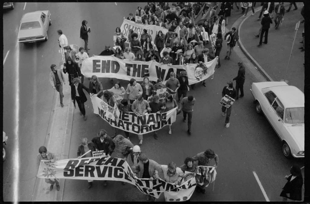 Protestors holding banners with words - End the War and Vietnam Moratorium