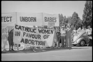 Protestors holding big banner that says - Catholic Women in Favour of Abortion and Unborn Babies.