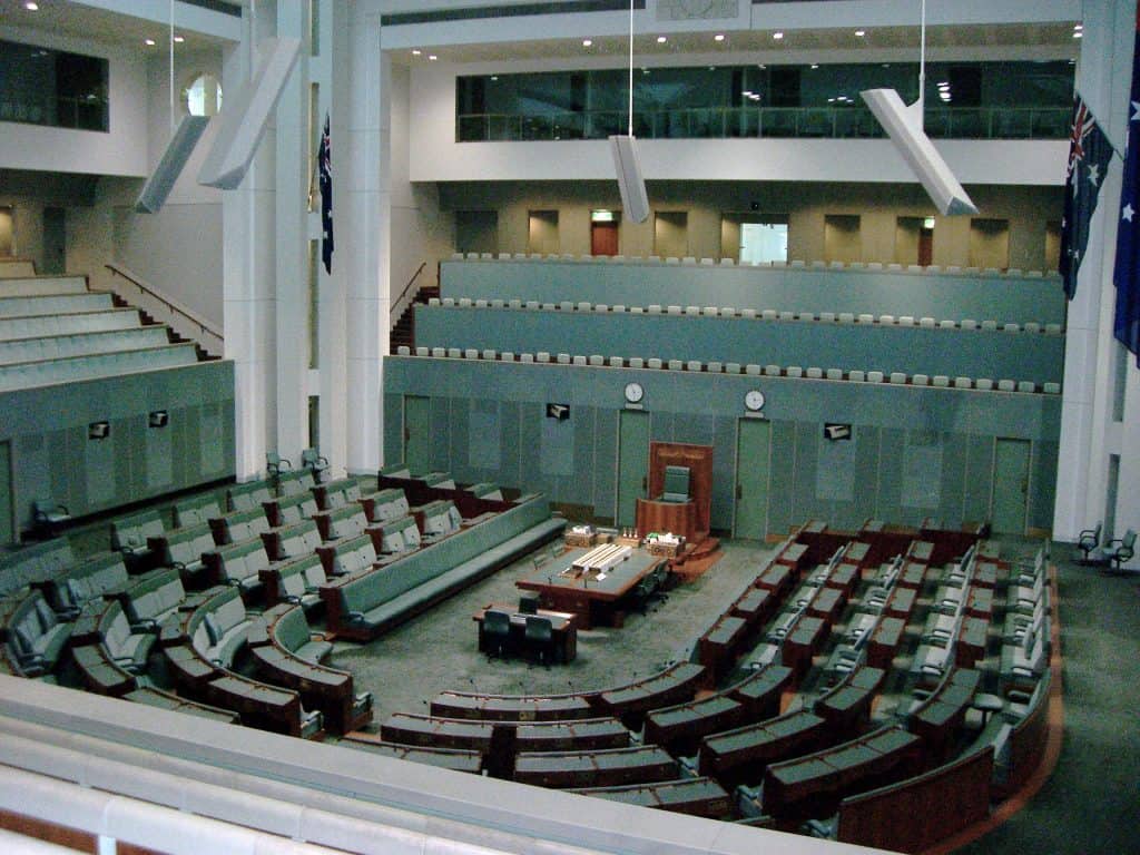 Photograph of Australian House of Representatives showing green seats in a U shape.
