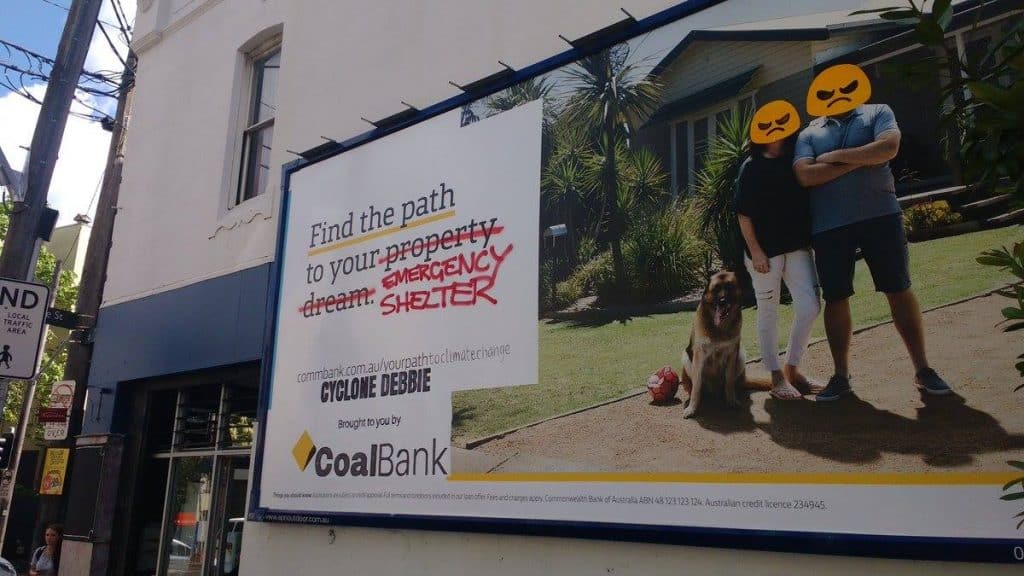 Photograph of a Commonwealth Bank advertising billboard that has been modified. The new slogan says 'Find your path to your emergency shelter' (emergency shelter replacing 'property dream'), Cyclone Debbie, Coal Bank.