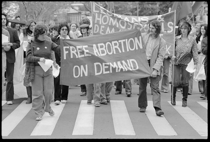 Counter-protesters opposed to Mary Whitehouse march behind a banner reading Free Abortion on Demand.