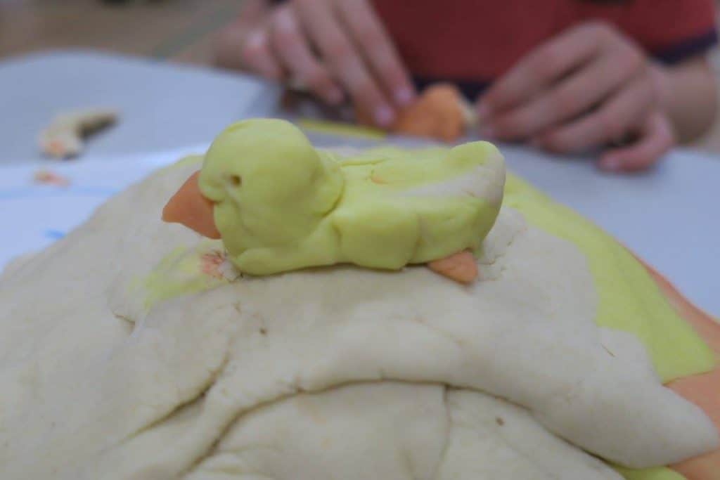 Yellow duck sculpture made from plasticine or coloured clay.