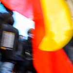 close up of Australian Aboriginal flag being carried by protestors