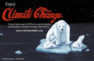 Greenpeace and Adbusters protest poster features a drawing of a mother polar bear and two cubs on a piece of ice in the ocean. The text reads: 'Enjoy Climate Change. Coca-Cola's use of HFCs to cool their drinks contributes to climate change. Ban HFCs'. The 'Climate Change' text is in red in the same font as the Coca-Cola logo.