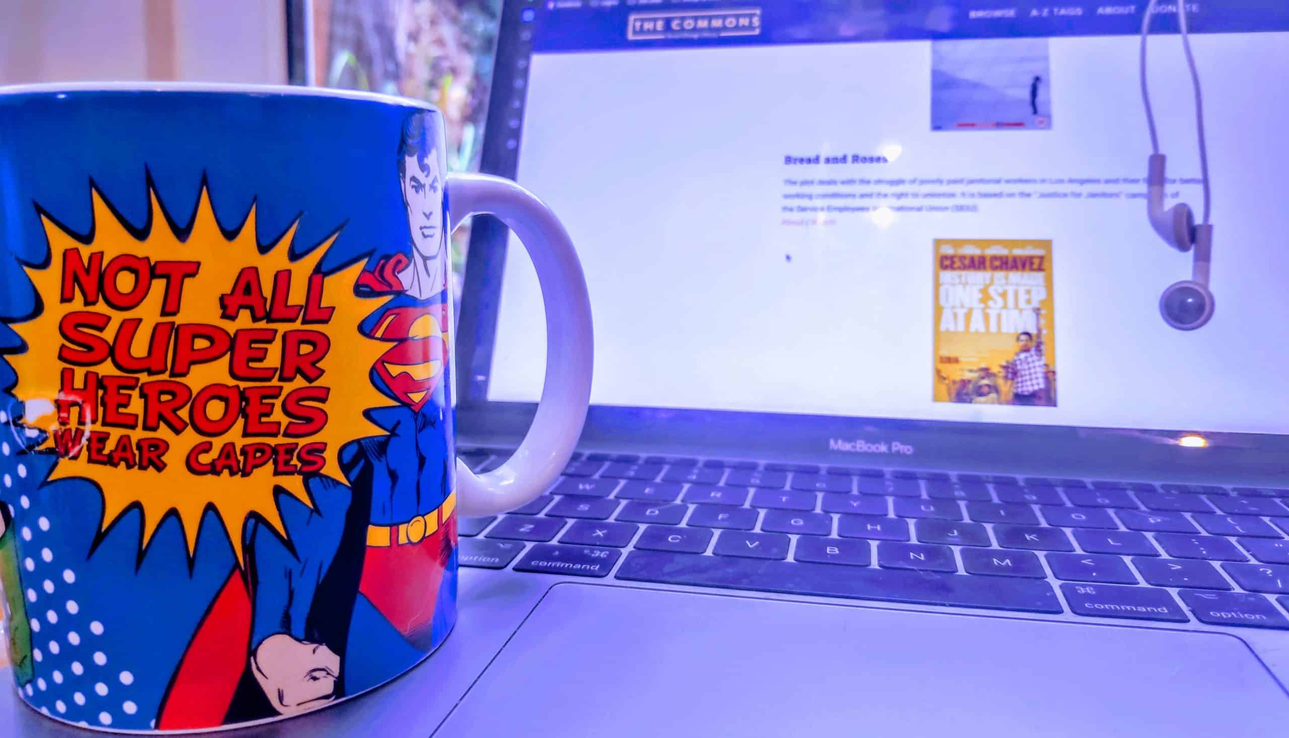 Mug sitting on laptop that says 'Not all super heroes wear capes'
