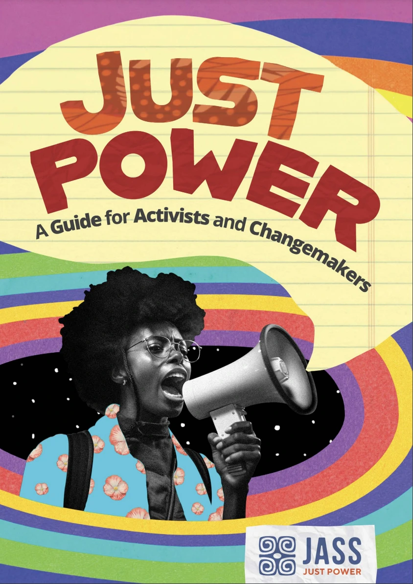 Guide cover - Title reads 'Just Power A Guide for Activists and Changemakers'. There is a woman speaking into a loudhailer. The speech bubble coming out of the loudhailer contains the title. There are rainbow colours surrounding her.