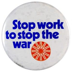 round badge that says Stop work to stop the war