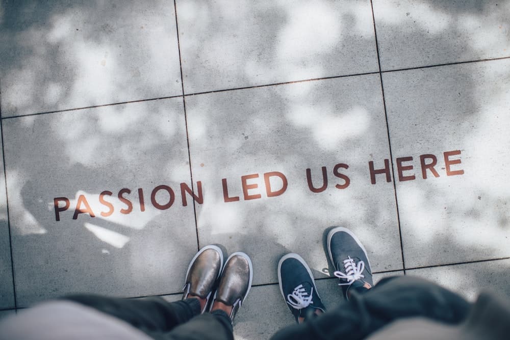 Photograph of two people standing on pavement