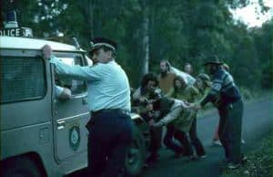 7 protesters on a road block a police vehicle during the 1982 Nightcap forest blockade in NSW, Australia.