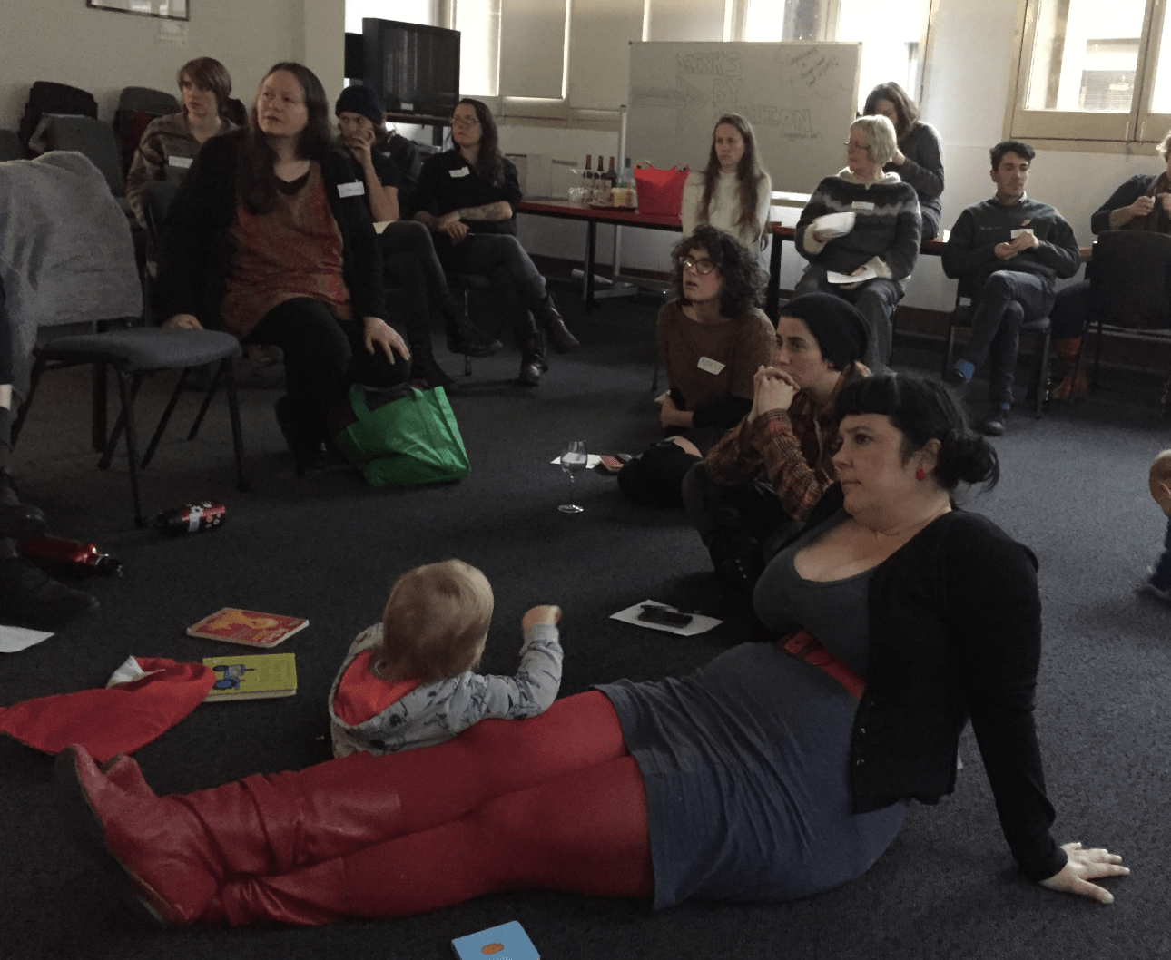 parents / carers and babies sitting in meeting||