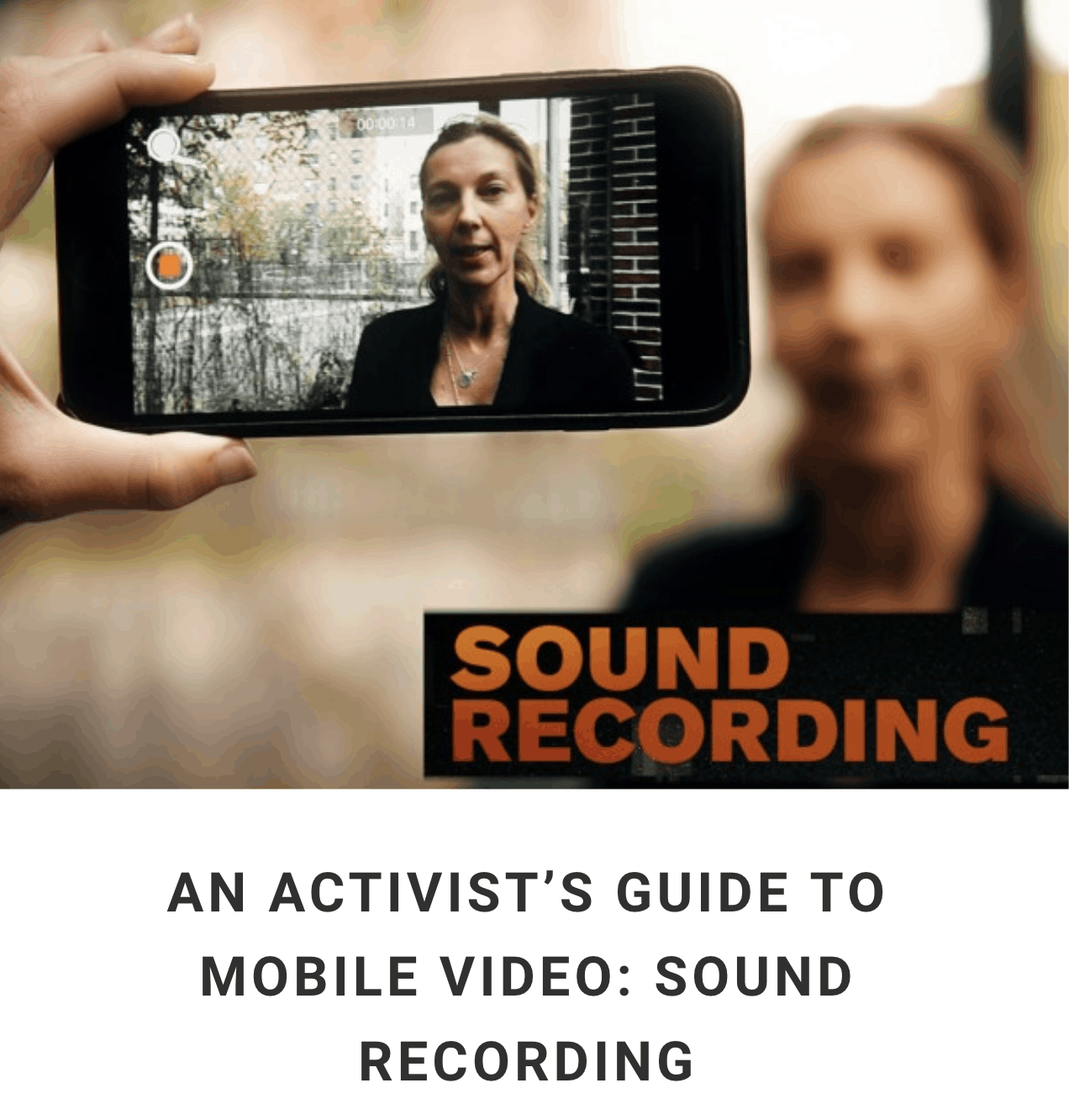 Hand holding mobile phone and filming woman