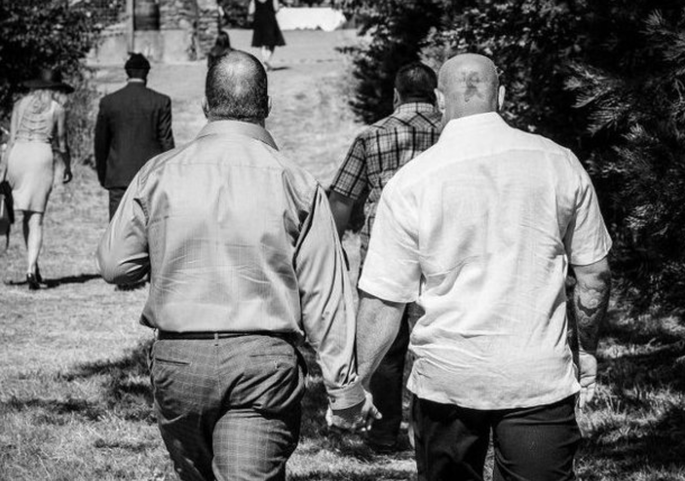 Two men holding hands.
