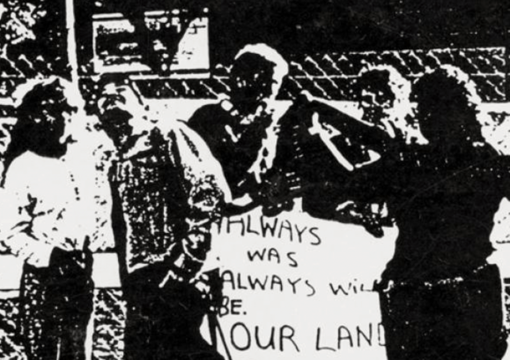 black and white image of Aboriginal activists with a sign saying Always as Always will be our land