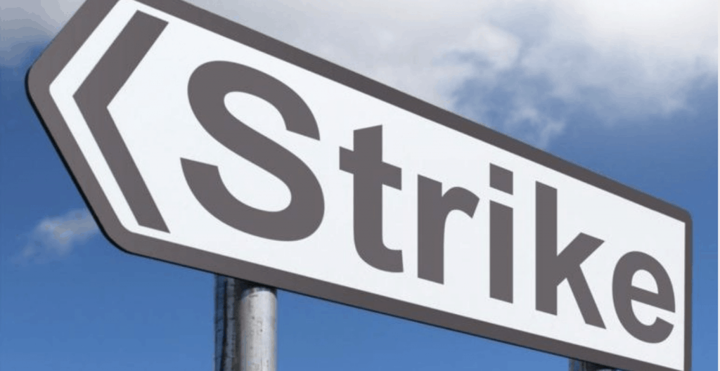 sign with arrows says strike