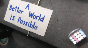 a sign on the road that says a better world is possible