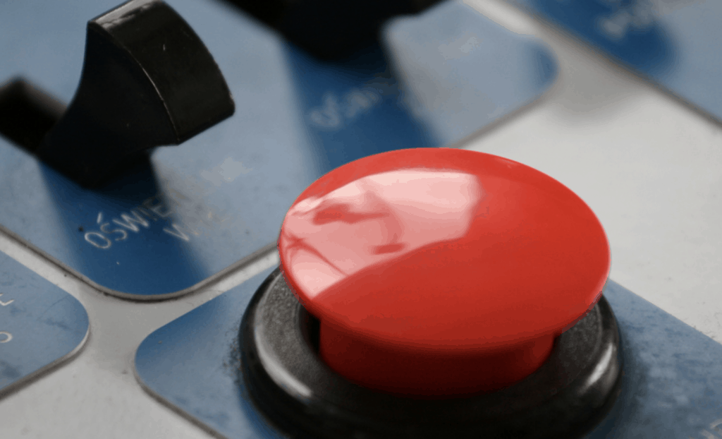 close up of red button on panel of buttons