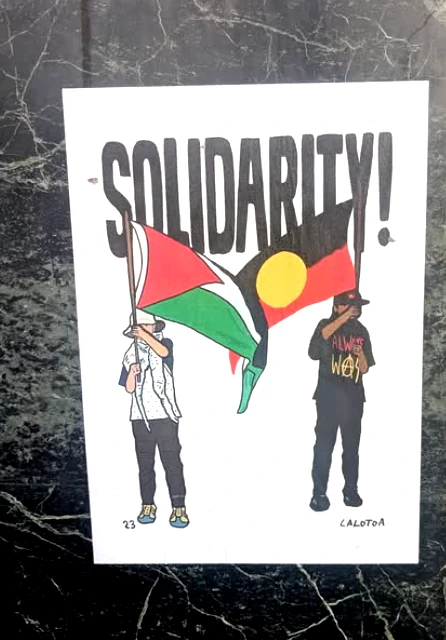 A poster with an illustration of two people underneath the word Solidarity. One holds an Aboriginal flag and one a Palestinian flag.|A sticker with Pride and Trans colours and an Antifa flag which reads Anti-Fascism is Community Self-Defence.