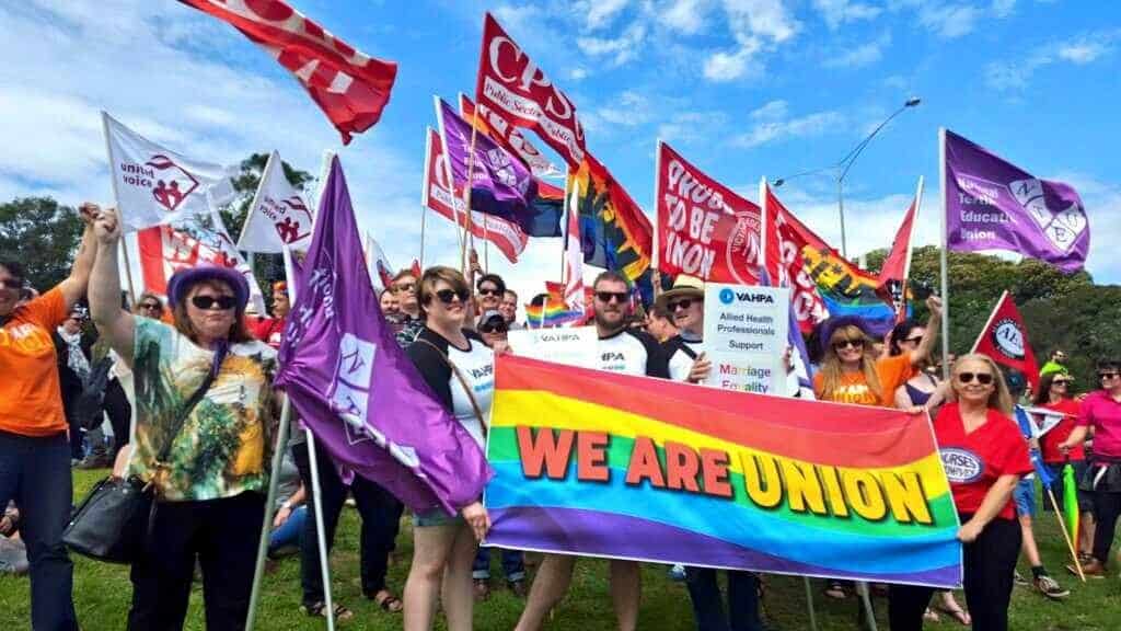 Happy stand with union flags and a rainbow coloured banner reading 'We Are Union'.