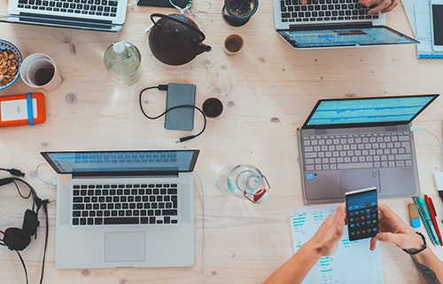 birds eye view of desk with office paraphernalia including phones