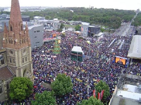 Aerial photograph of huge crowd filling Federation Square and surrounding streets.