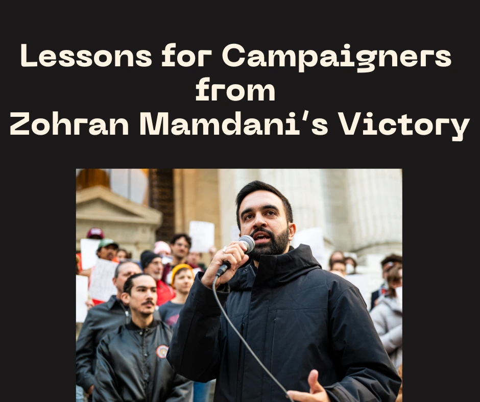 Zohran Mamdani standing with a microphone speaking to an audience. There is a group of people behind him on stairs. Title reads 'Lessons for Campaigners from Zohran Mamdani's Victory."|Zohran Mamdani speaks at a rally. He speaks into a microphone with a supportive crowd behind him.