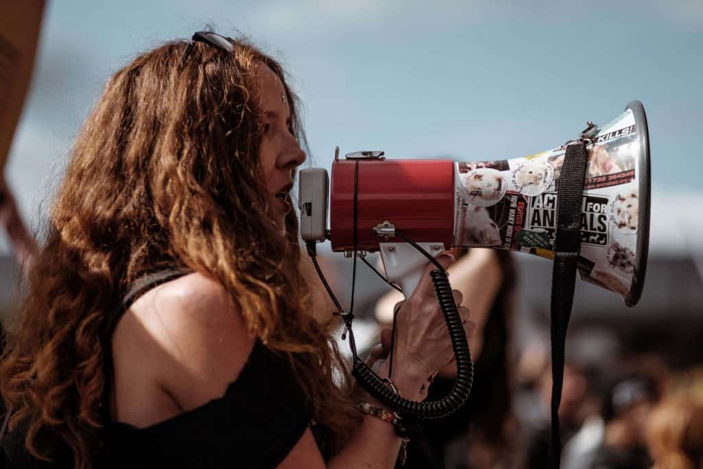 Female protestor speaking into a megaphone