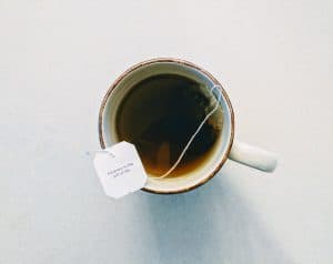 A cup of black tea on a table, shot from above