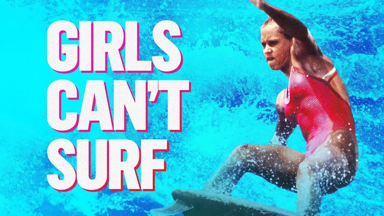 Young woman in pink swimming costume surfing a wave