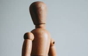 Close up of the head and shoulders of a movable artist's model, made out of wood