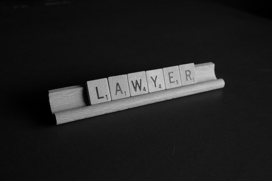Black background with white scrabble board and Lawyer spelled out using scrabble letters.
