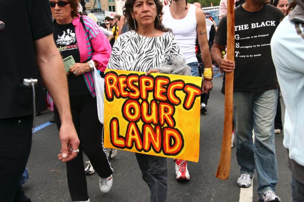 Protester holding sign that says Respect our land